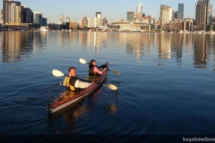 a small boat in a harbor next to a body of water