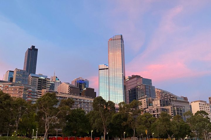 a large body of water with a city in the background