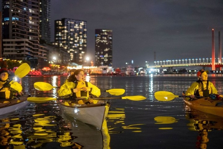 a group of people on a boat in the water