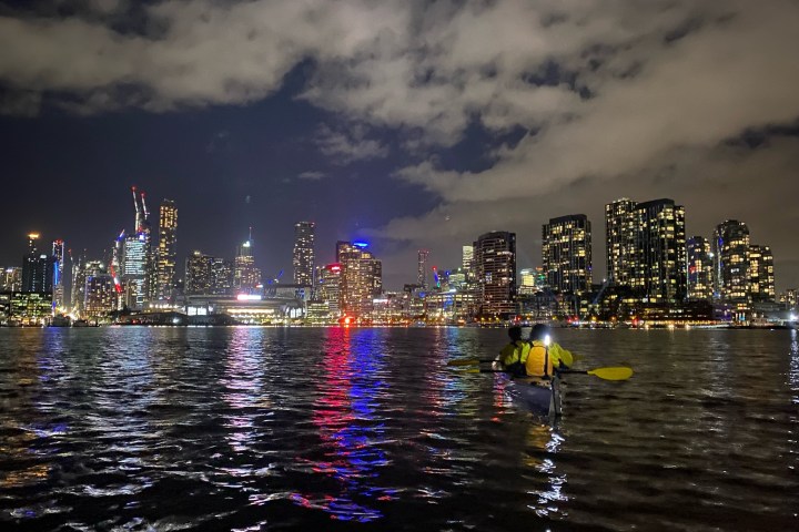 a body of water with a city in the background